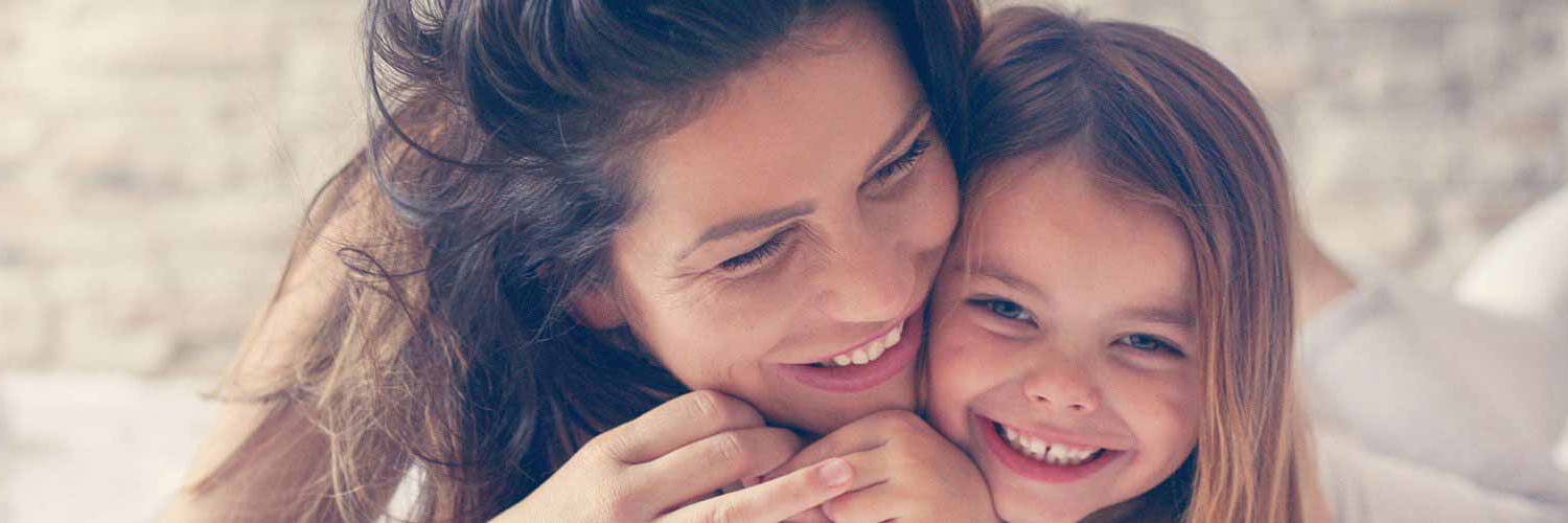 A smiling mother and child at Auburn Centre Dental Office in Waterloo ON