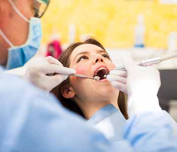 Image of a Dentist examine a Patient's Mouth
