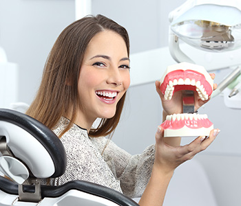 A young lady taking a denture in Waterloo, ON area